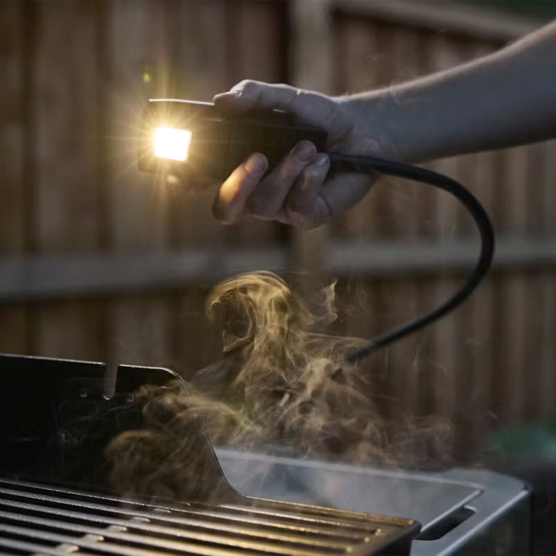 Weber Works Flex Light - Snap On, attached to a BBQ shining it up