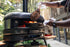 Person grilling a large piece of meat on a Gozney Pizza oven