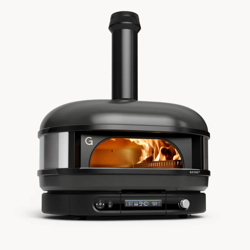 Black outdoor pizza oven with visible fire inside on a white background