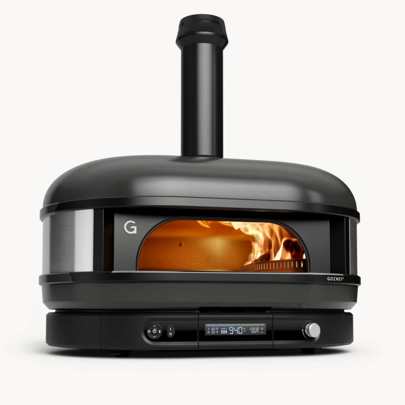 Black outdoor pizza oven with visible flame inside on a white background